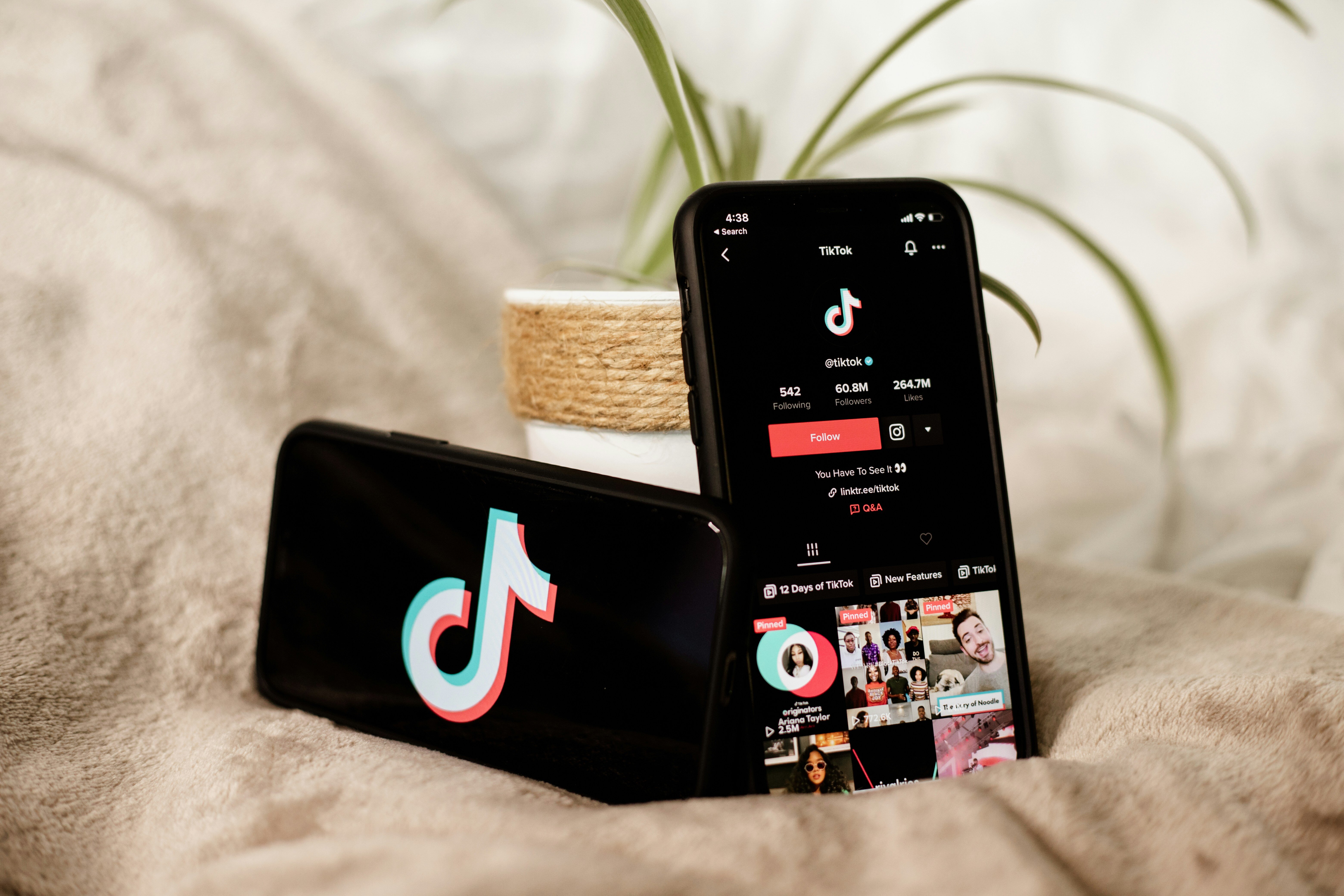 two mobile phones and devices showing the TikTok home page and account on their screens